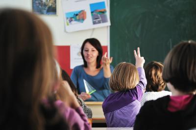 happy teacher in school classroom