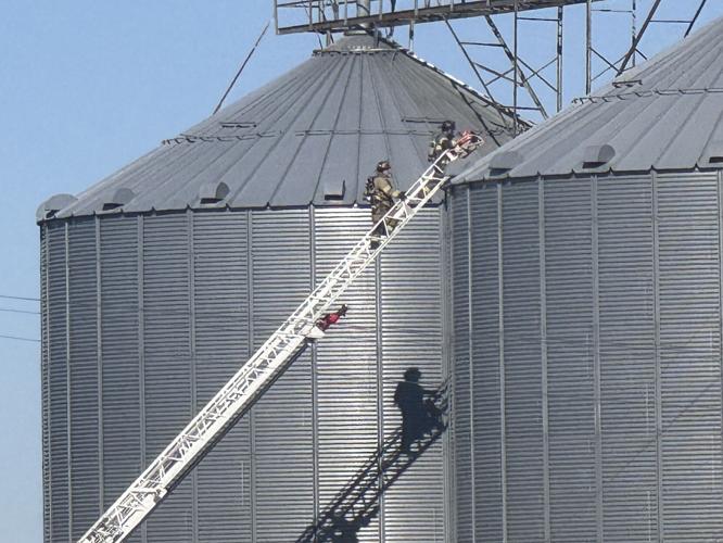 Firefighters on top of ladder truck at Coles Station
