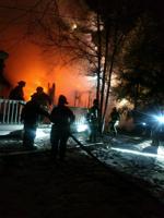 Champaign firefighters work  to put out fully engulfed home