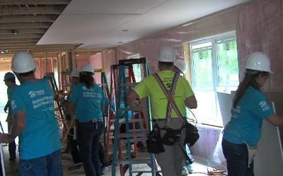 Board by board, group builds house for a cause