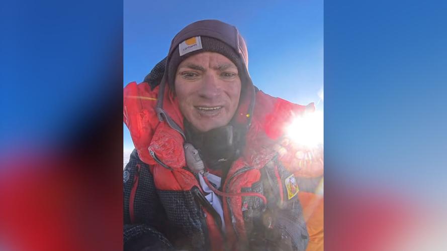 Nick Selby stands atop Mount Everest
