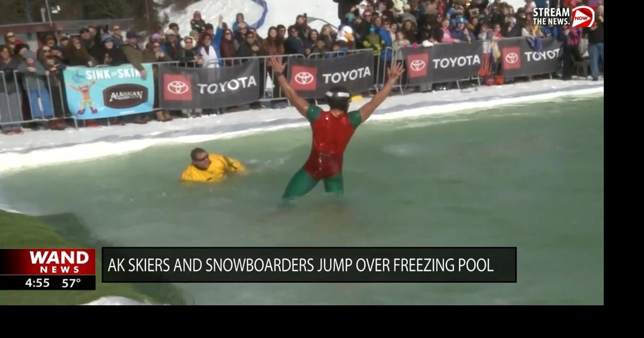 Alaska skiers and snowboarders show off skills jumping over freezing pool