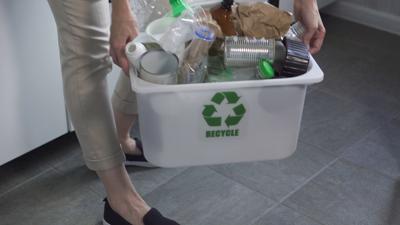 Person with a recycling bin