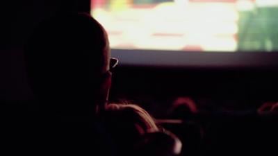 people-are-watching-a-movie-while-sitting-in-a-movie-theater-SBI-349439896.jpg