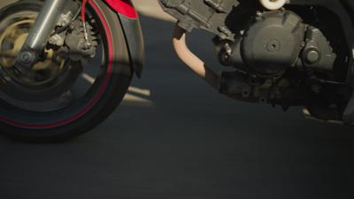 close-up-of-a-moving-power-bike-showing-two-female-riders-legs-one-wearing-sneakers-th-SBI-351226453.jpg