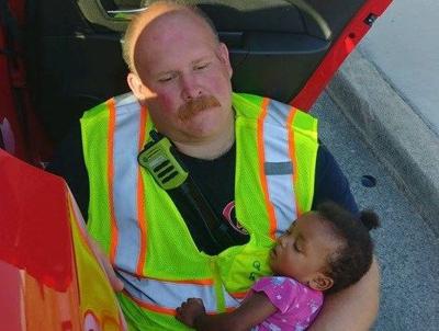 Touching photo shows firefighter comforting baby after wreck