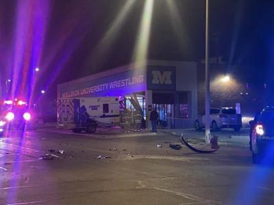 Ambulance crashes into building after being hit by vehicle