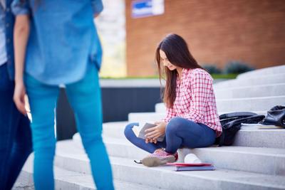 Teen reading outdoors