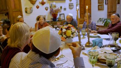 Group Of People Eating Matzah