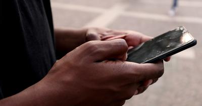 black-african-person-hands-using-smartphone-browsing-and-touching-screen-SBI-349571555.jpg