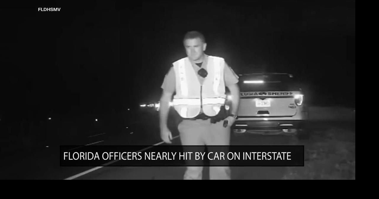 Florida officers narrowly avoid being hit by car on interstate