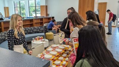 Sophie Schwalbach (left) provides Millikin students with fire prevention equipment.