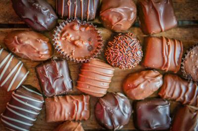 Assorted Chocolate pralines on brown background