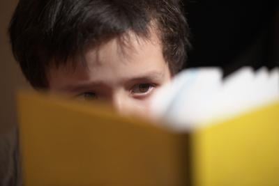 Young boy reading a book