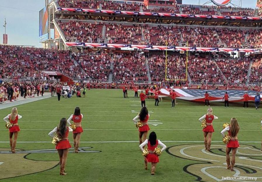 San Francisco 49ers cheerleader kneels during national anthem