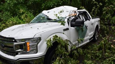 Two men hospitalized after vehicles crushed by falling tree in severe ...