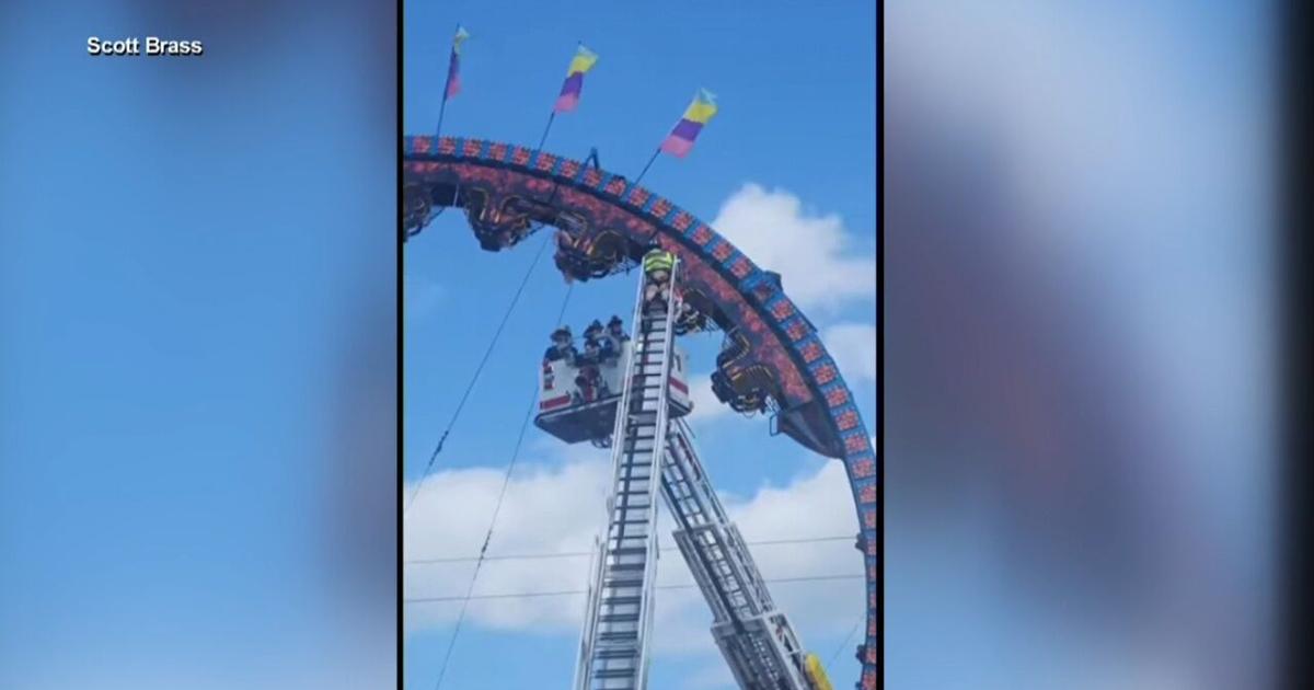 several people stuck upside down on fair ride Video