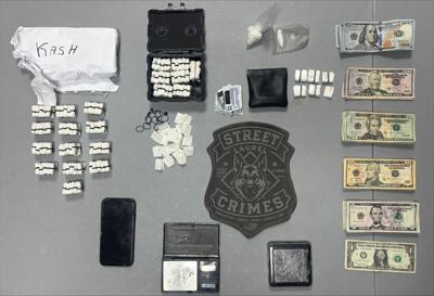 All items seized as part of this drug bust are laid out on a table. 