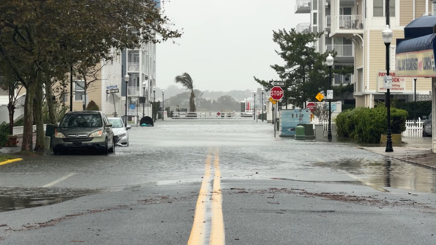 Wicomico Street in Ocean City experiencing high tide. Half the street is flooded, with a view of S Philadelphia Ave being completely inundated with water.