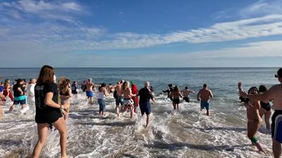 Swimmers Dashing Into the Ocean