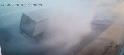 Strong winds, possibly from an EF0 tornado, move an entire tractor-trailer.