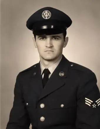 Black and white photo of a man in a military uniform. 