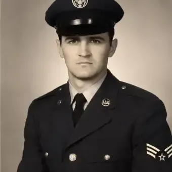 Black and white photo of a man in a military uniform. 