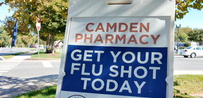 Sign outside Camden Pharmacy urging people to get their flu shot.