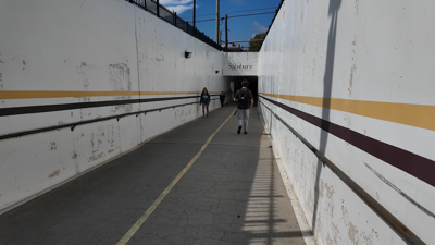 A man walking toward the opening of the Salisbury University underground tunnel