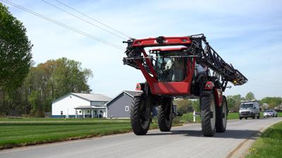 Sprayer driving down road