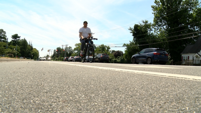 Bicyclist riding in bike lane along South State Street in Dover.