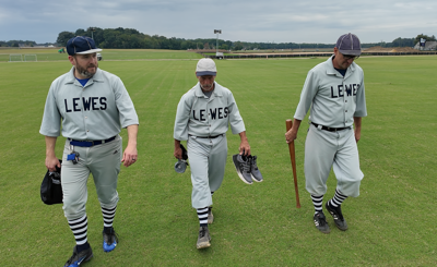 Three Lewes Base Ball Club players walking on the field next to each other