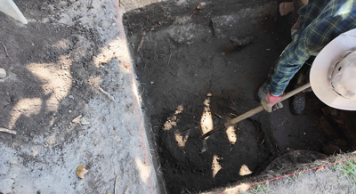 An archaeologist digs in the backyard of the Maull House in Lewes during an excavation hosted by the local Daughters of the American Revolution chapter. (WBOC)