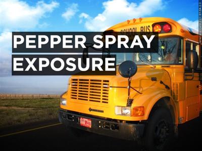 Text over a school bus that reads "pepper spray exposure."