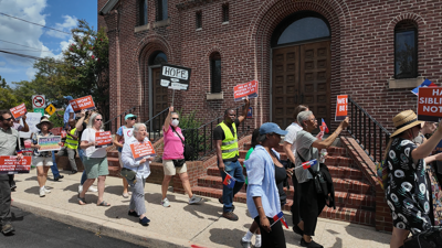 Protestors walking on the sidewalk at the Salisbury Haitian March