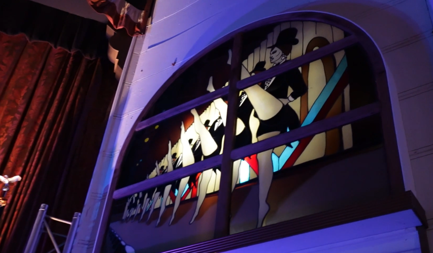 Stained glass windows of dancers kicking in a line at the Millstone Theatre in Millsboro.