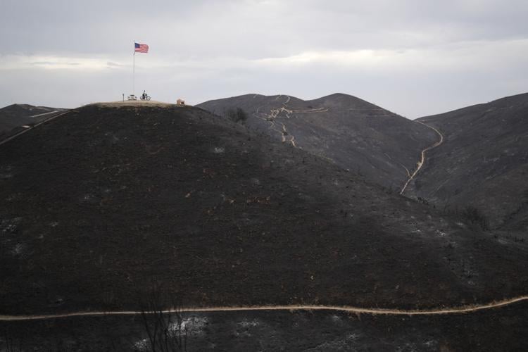 Photos show wildfire fueled by high winds engulfing coastal homes in Southern California