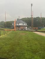 Storm damage: downed power poles and destroyed fencing at Dover's Little League complex.