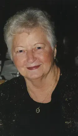 Woman with Short white hair, wearing black top with dark background