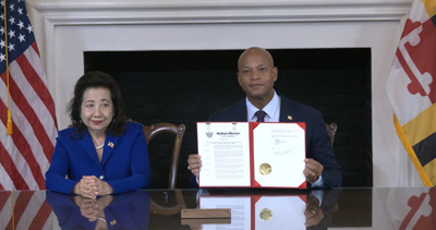 Maryland Governor Wes Moore holds up a newly-signed executive order on data centers