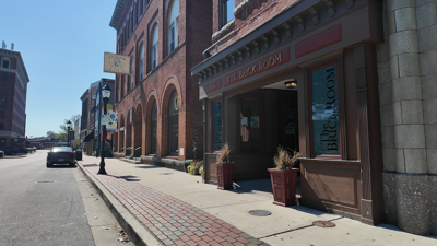 the exterior of the Brick Room building along a sidewalk