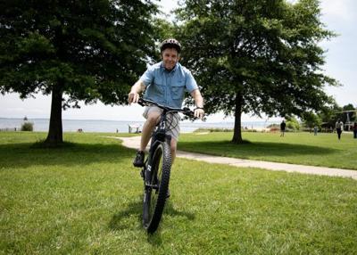 A man tests an e-bike during a Department of Natural Resources event at Sandy Point State Park.