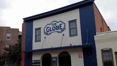 Front of a building reading "The Globe". Building in between two buildings in Berlin, Maryland.