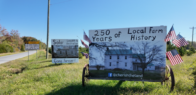 Community-made signs addressing concerns with large-scale solar energy project along Lighthouse Road in Smyrna.
