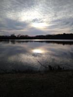 The sun reflected in the water at Heron Park in Berlin