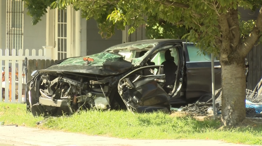 Car crashed, front bumper and side door mangled.