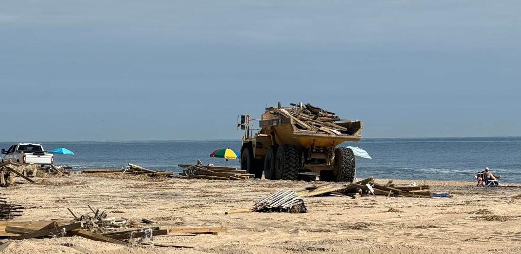 A truck moves storm debris up Ocean City's beach after a nor'easter slammed the shore last weekend.
