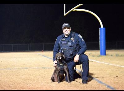 K9 Kazi poses for a photo with her handler