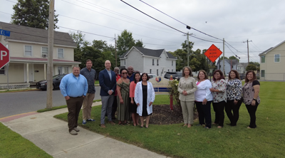 Staff from Rosa takes a picture with Rep. Blunt Rochester