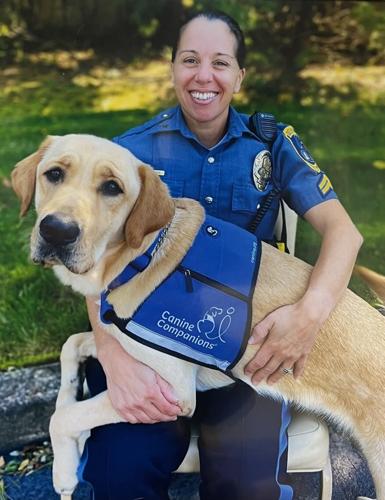 Delaware Capitol Police facility dog handler Senior Corporal Donna DiClemente is shown with Vinn.